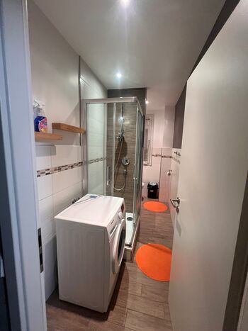 Sauberes, modernes Badezimmer mit Dusche, Waschmaschine und WC. Ideal für den täglichen Gebrauch. Sauberes, modernes Badezimmer mit Dusche, Waschmaschine und WC. Ideal für den täglichen Gebrauch.