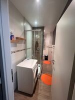 Sauberes, modernes Badezimmer mit Dusche, Waschmaschine und WC. Ideal für den täglichen Gebrauch. Sauberes, modernes Badezimmer mit Dusche, Waschmaschine und WC. Ideal für den täglichen Gebrauch.