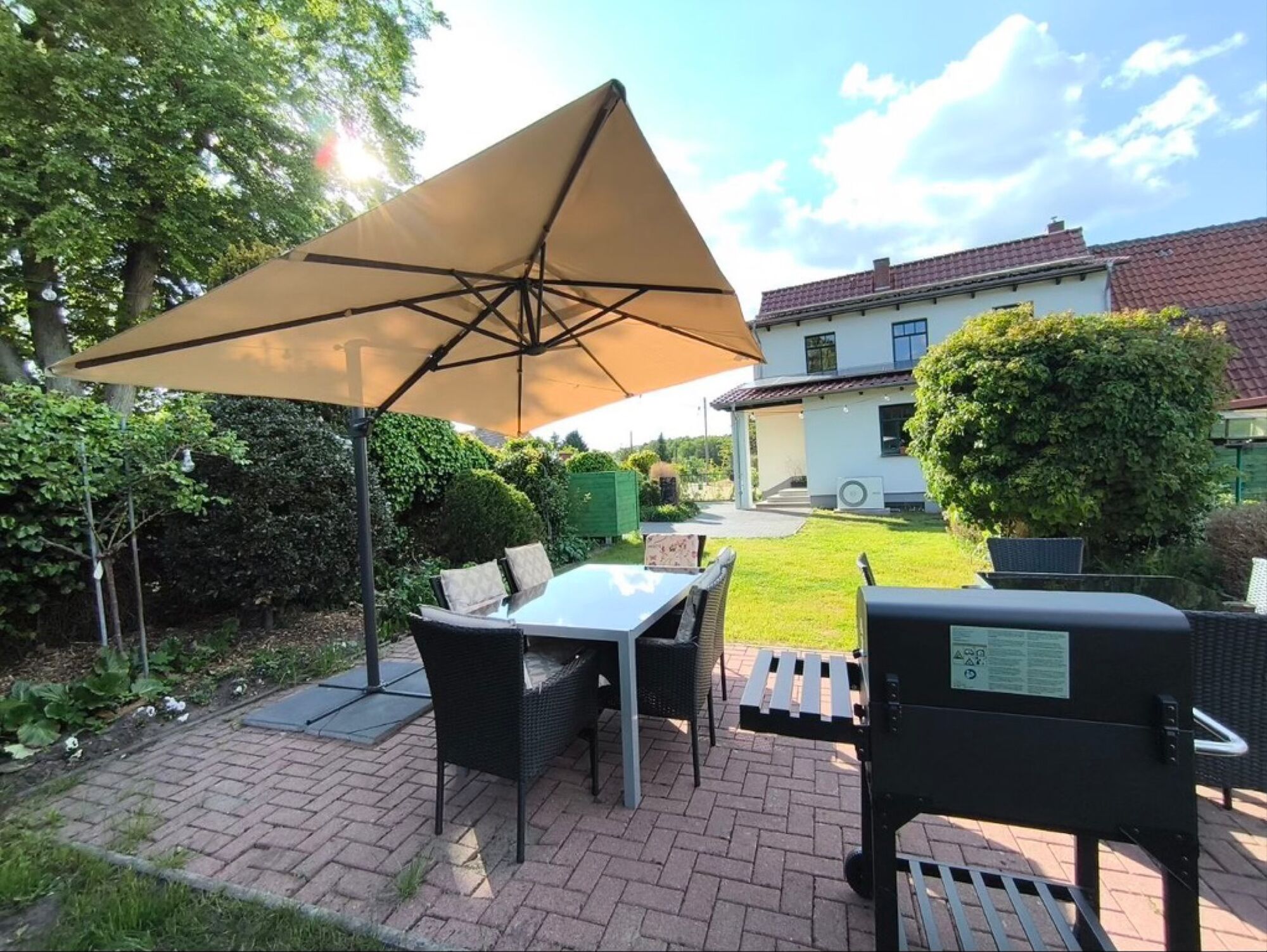 Garden with garden furniture, sun loungers, barbecue and children's play area