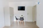Schlafzimmer 2 mit zwei Einzelbetten, Sitzecke und Smart TV 