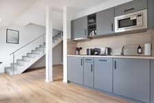 Modern eingerichtete Studios mit voll ausgestatteter Küche Bild 28