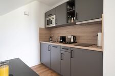 Modern eingerichtete Studios mit voll ausgestatteter Küche Bild 13
