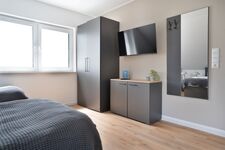 Modern eingerichtete Studios mit voll ausgestatteter Küche Bild 25